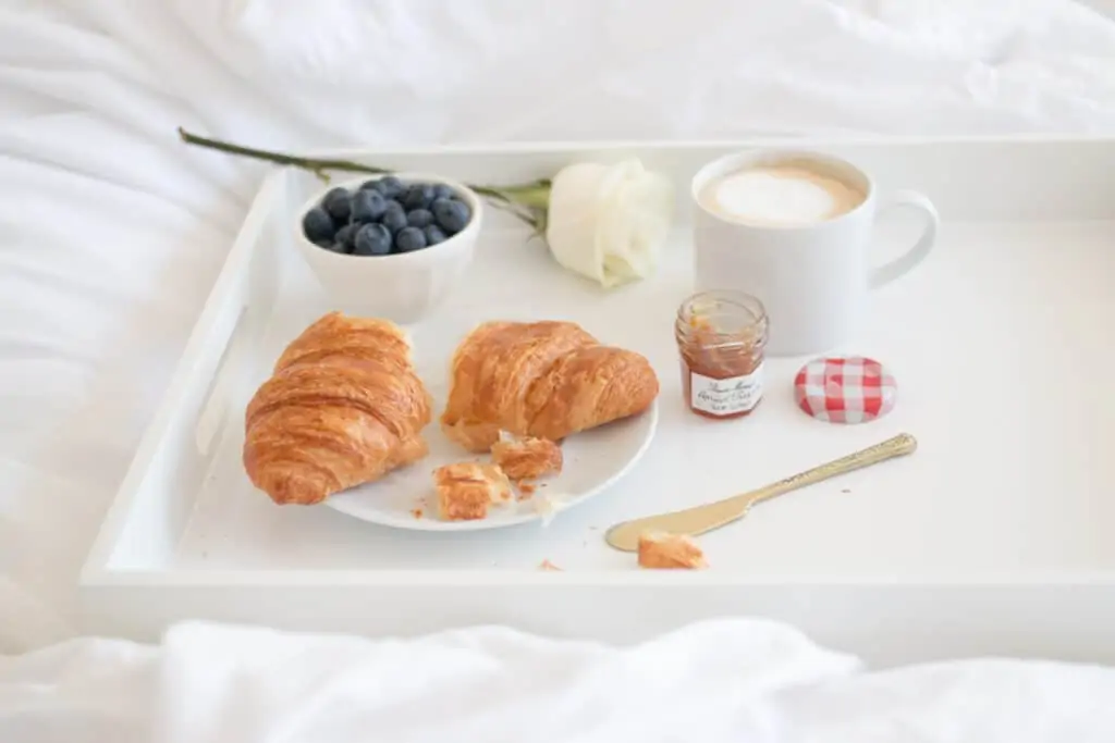 croissant , coffee, blueberries, and jam for breakfast croissant , coffee, blueberries, and jam for breakfast